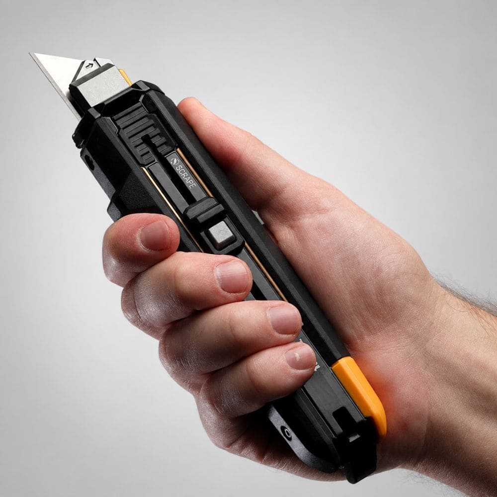 Hand holding the ergonomic utility knife configured in standard straight cutting mode.