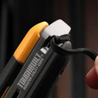Close-up view of the integrated lanyard hole at the end of the knife handle with a black cord threaded through.