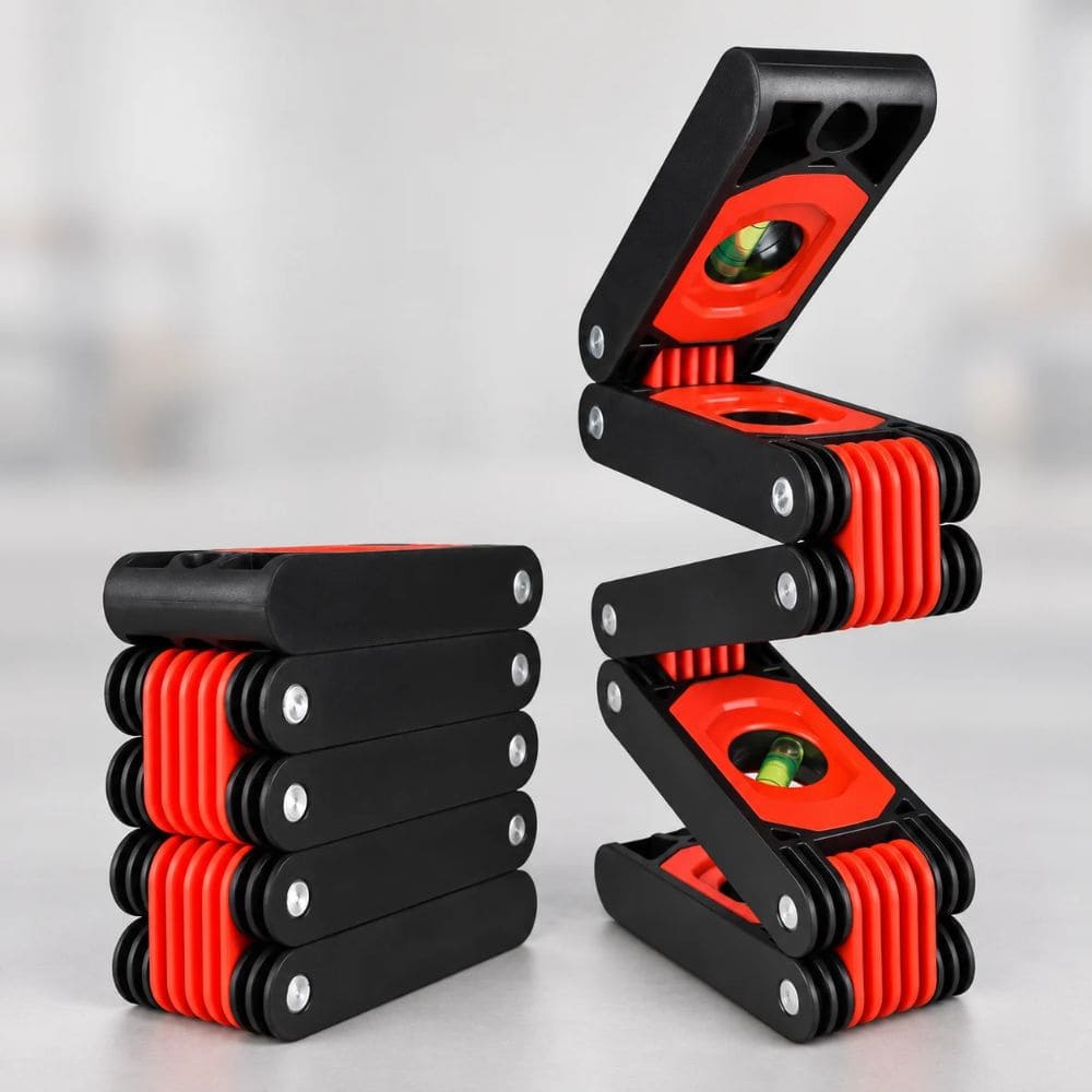 Multi-joint folding spirit level in folded compact block form next to a partially unfolded Z-shape configuration showing spirit vials.
