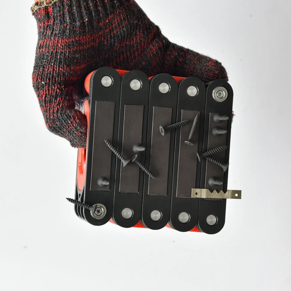 Gloved hand holding the folded magnetic level ruler demonstrating strong magnetic holding power with screws and metal brackets.